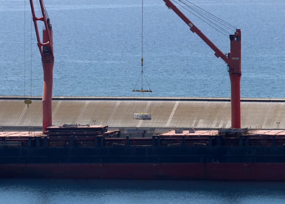 A-crane-lifts-material-onto-a-cargo-vessel-expected-to-take-aid-to-Gaza-from-Cyprus-at-the-por...jpg