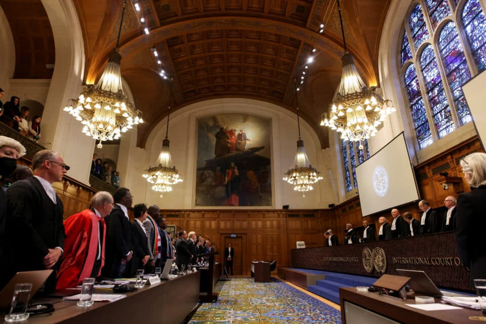 People-stand-inside-the-International-Court-of-Justice-ICJ-as-judges-hear-a-request-for-emerge...jpg