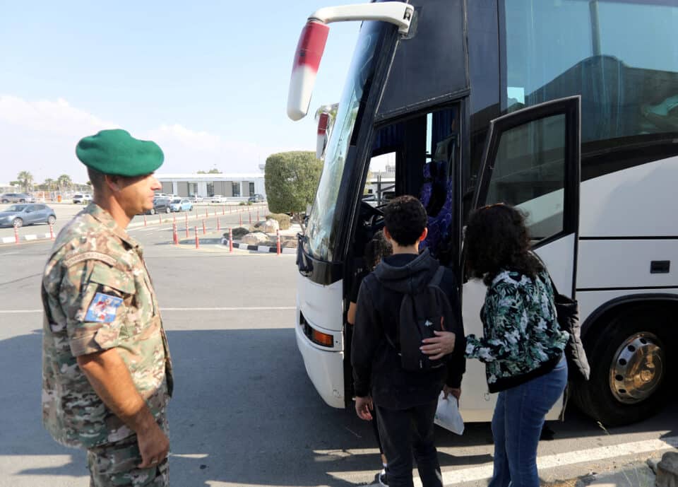 People-who-were-evacuated-from-Israel-board-a-bus-after-arriving-at-the-Larnaca-International-...jpg