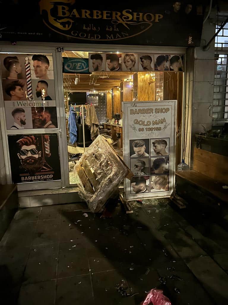 A-Syrian-owned-barbershop-with-a-smashed-front-window.jpg