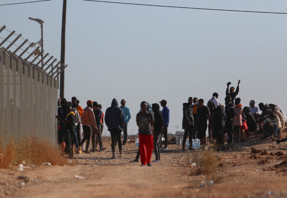 feature-theo-Migrants-outside-the-Pournara-camp-where-asylum-claims-are-processed-960x663.jpg